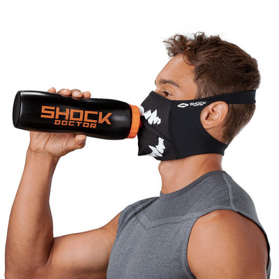 Black White Fang Play Safe Face Mask – Male Model Wearing Protective Safety Face Mask while Drinking a Hydration Water Bottle - Left Angle