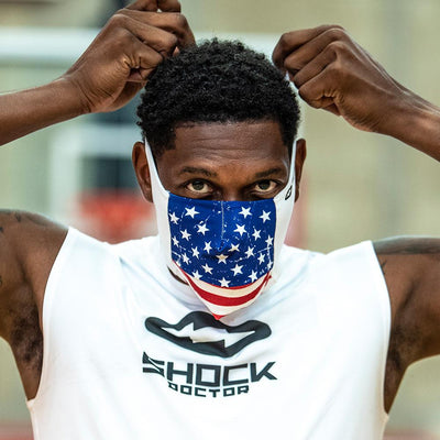 USA Stars & Stripes Play Safe Face Mask – Male Athlete Placing Protective Safety Face Mask Over Mouth and Nose – Front Angle